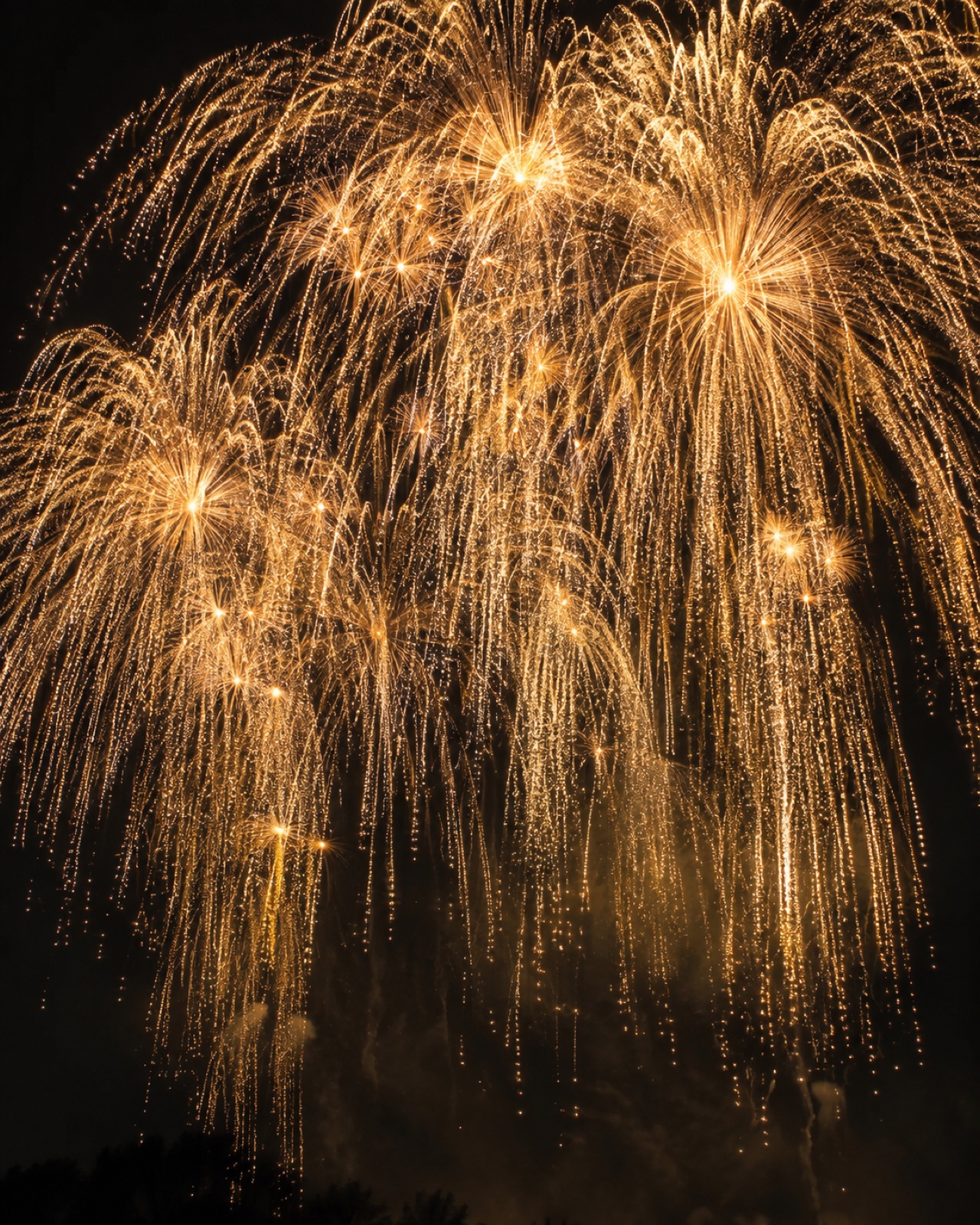 Golden fireworks cascading across the night sky